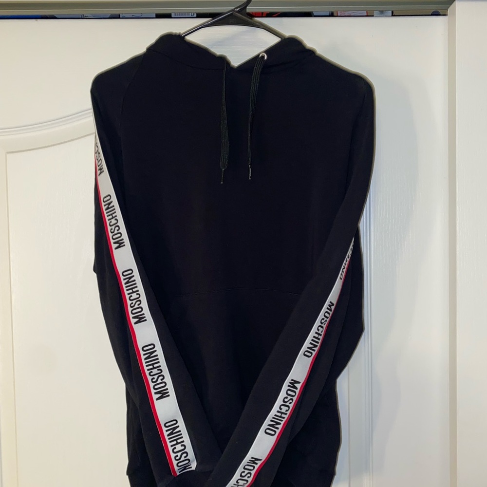 Black, red, and white Moschino hoodie.
